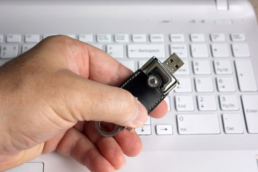 Elite store of memory in leather cover on the laptop keyboard