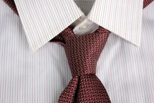 The tie tied in knot round a shirt collar