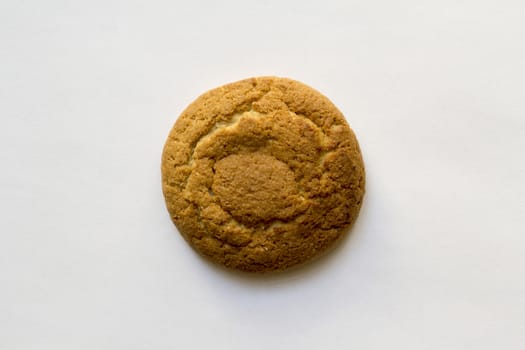 one oatmeal round biscuits closeup on white background