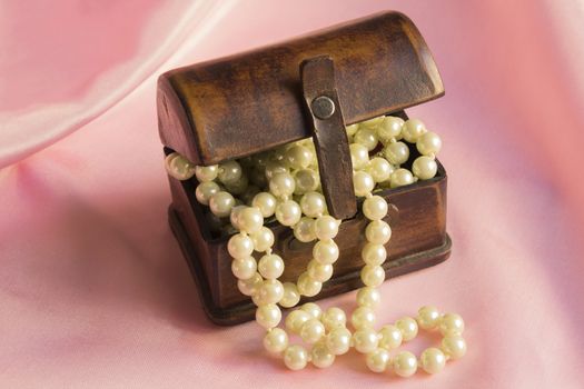 Pearl Necklace in an ancient casket on a pink silk