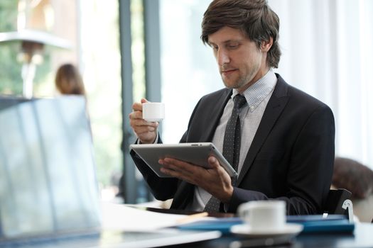 Business man with tablet computer in cafe