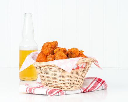Wicker basket filled with spicy buffalo style chicken wings.