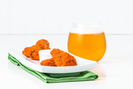 Spicy buffalo chicken wings in a less traditional more elegant setting.