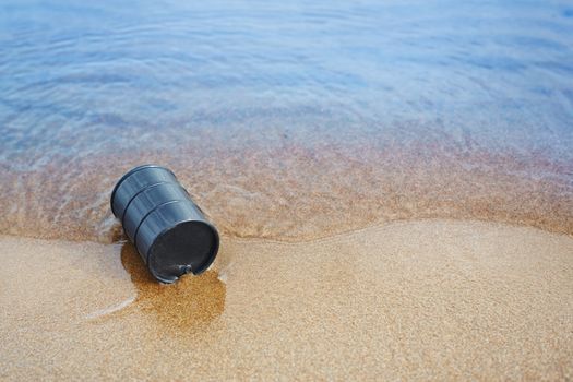 Oil barrel abandoned at the sea coast