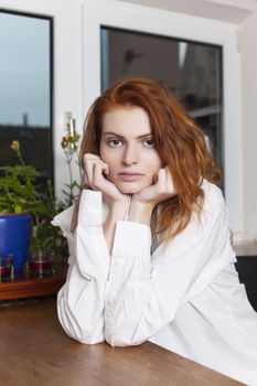 pensive redhead in the kitchen