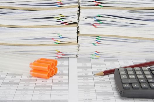 Specimen tube for laboratory test with orange cap with brown pencil and calculator on finance account have overload of paperwork with colorful paperclip and envelope as background.