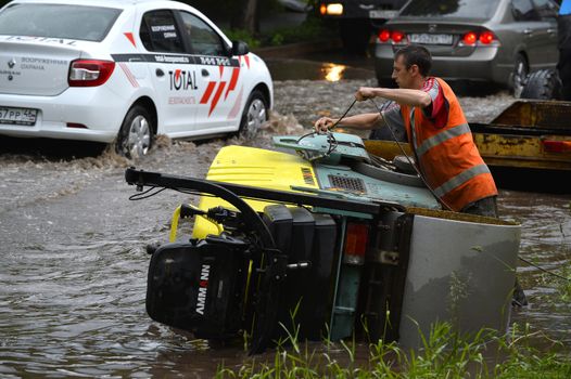 Car rides in heavy rain on a flooded road
