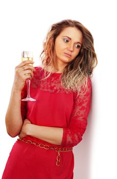 sad woman with a glass of red wine in kitchen