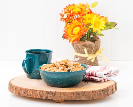 Cereal and coffee served in a tin bowl and cup.