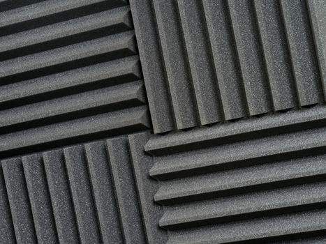 Background photo of recording studio sound dampening acoustical foam or tiles.
