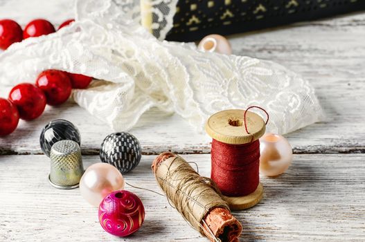 White lace,spool of thread and beads for needlework