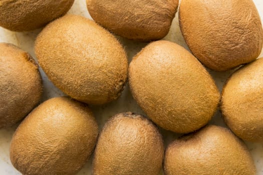 Exotic juicy, fresh Brown, hairy Kiwi fruit on a white background.