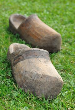 Two old Dutch clogs on the grass.