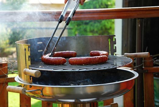 Grill sausages due to garden party.