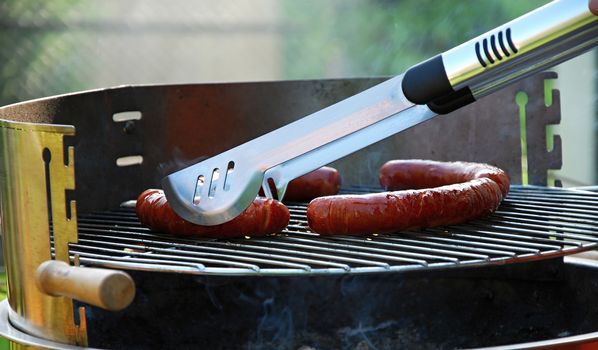 Grill sausages due to garden party.