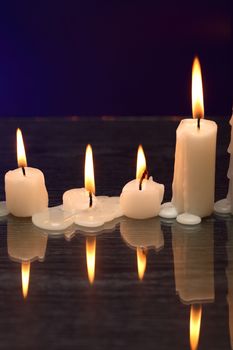 Set of lighting candles in a row on nice dark background