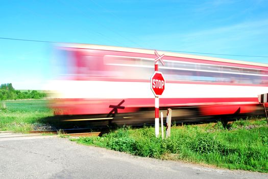 Commuter train passed the grade crossing.