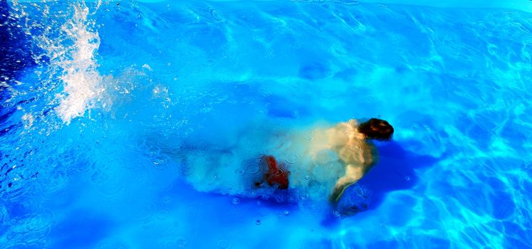 Swimmer with red suit under the water.