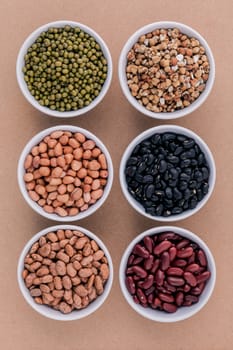 Assortment of beans and lentils in wooden spoon isolate on white  background. mung bean, groundnut, soybean, red kidney bean , black bean ,red bean and brown pinto beans .