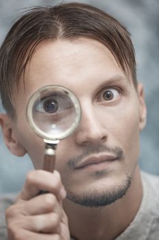 Man with magnifying glass. Vertical portrait