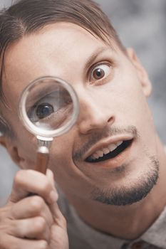 Man with magnifying glass. Vertical portrait