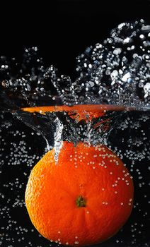 Mandarin falling down to the cold water and making splash.