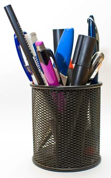 Colored pen and pencil in office pot, isolated on white background.