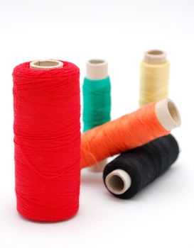 Detail image of various colored threads on white background.