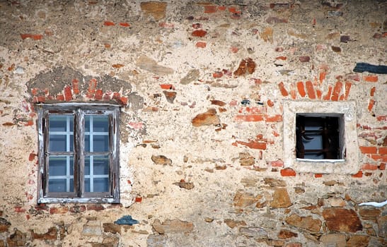 Old brick wall with old windows.