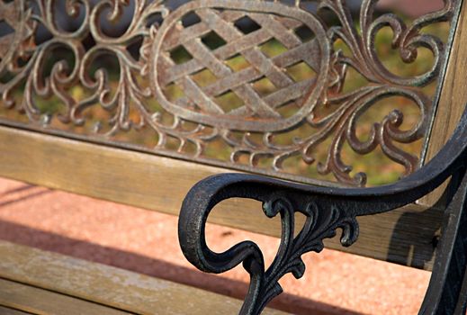 Detail of olod park bench in park.