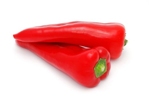 Fresh red peppers on the white background.