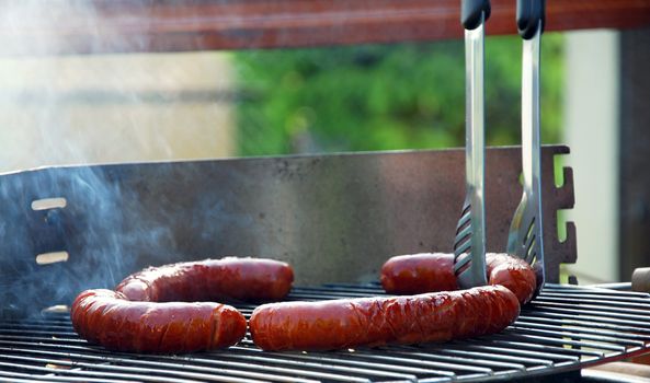 Grill sausages due to garden party.