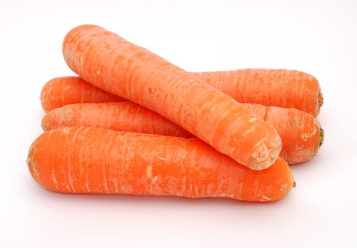 Fresh carrots on the white background and on the stack.