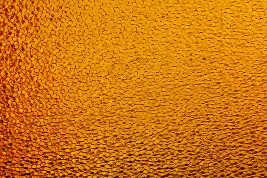 Abstract color pattern from orange window with grain surface.