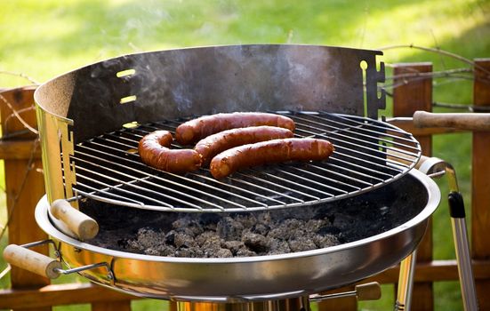 Grill sausages due to garden party.