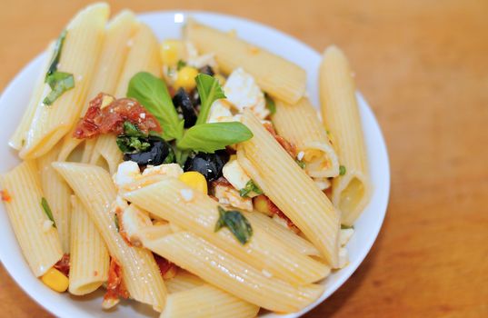 Pasta salad with olives and dry tomatoes.