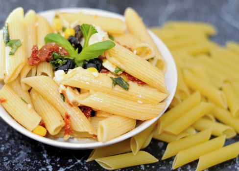 Pasta salad with olives and dry tomatoes.