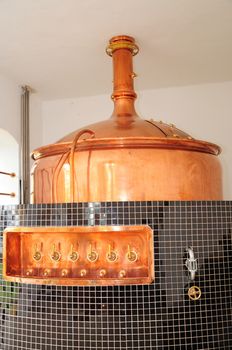 Metal beer tank in brewery.