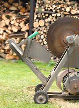 Circular saw with woodshed in background.