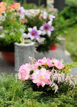 Funeral flowers placed on the grave at All souls holiday.