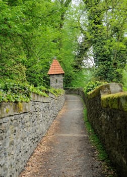 Old castle stone path in big garden.