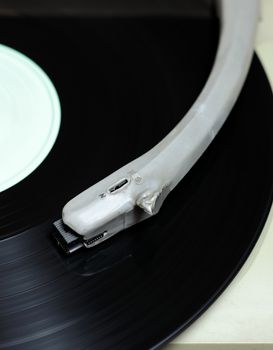 Closeup view at playing vinyl disc.