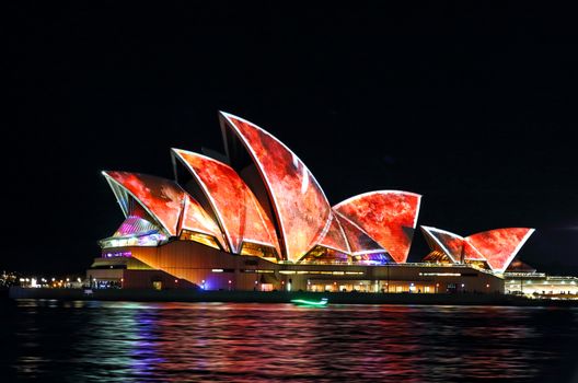 SYDNEY, AUSTRALIA - MAY 29, 2016;  Sydney Opera House in moving colour of patterns, shapes and lines during the Vivid Sydney Annual Event.  Displaying red patterns