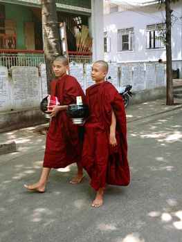 AMARAPURA, MYANMAR, APRIL 21, 2013 : young buddhist novices walk in Mahagandayon monastery near Mandalay, Myanmar (Burma)