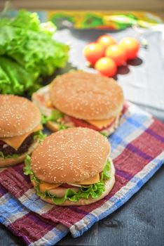 Closeup of home made burgers on wooden table