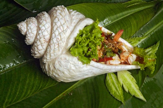Thai shrimp salad serve in taro root carving