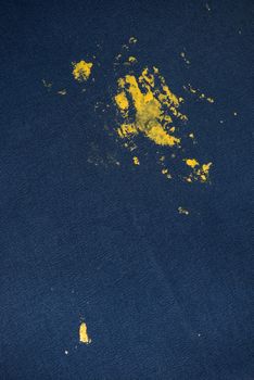 Blue Jeans and sneakers stained with yellow paint