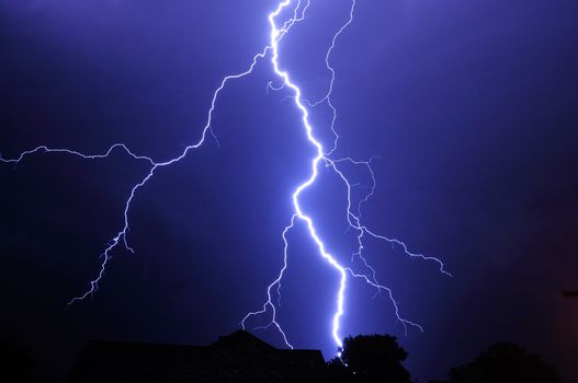 Night shot with big thunderstorm at the starry sky.