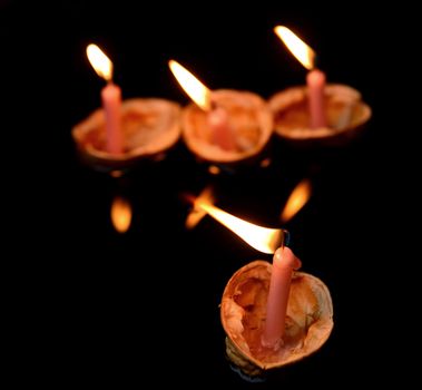 Christmas traditions decoration of nutshells with candles in water.