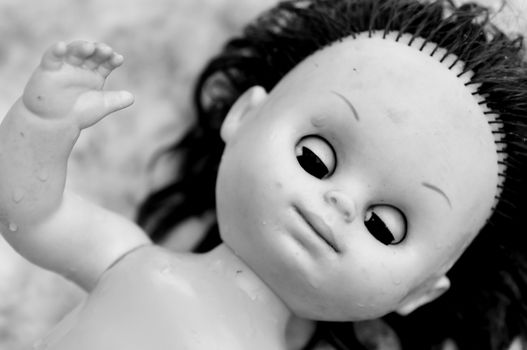 Black and white shot of scary plastic doll.